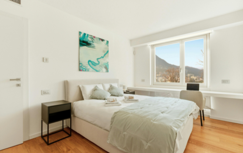 Bedroom with white walls, and a king sized bed in the middle